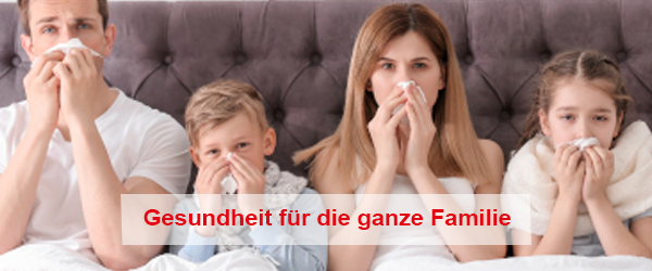 Eine ganze Familie mit Erkältung im Bett